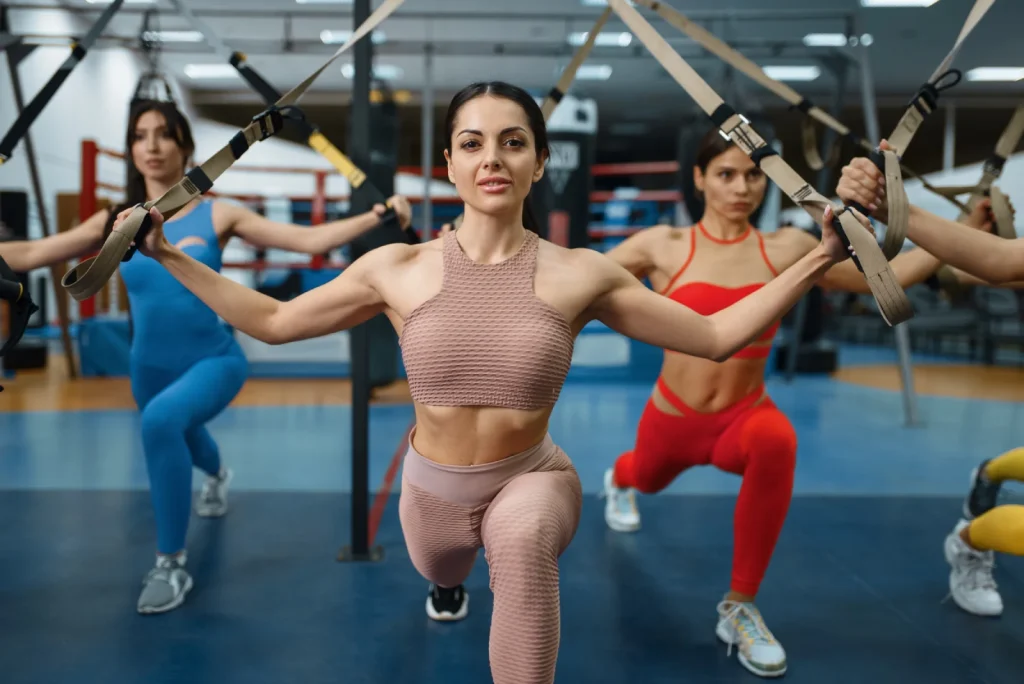 group of attractive women doing exercise in gym